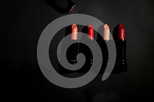 Lipstick. Fashion Colorful Lipsticks over black background. Lipstick tints palette, Professional Makeup and Beauty. Beautiful Make