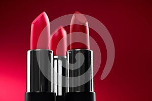 Lipstick. Fashion red colorful Lipsticks over red background. Matt Red lipstick tints
