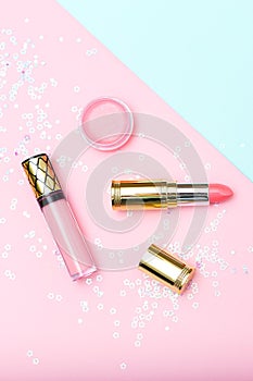Lipstick gold and beauty product on pastels background. Vertical