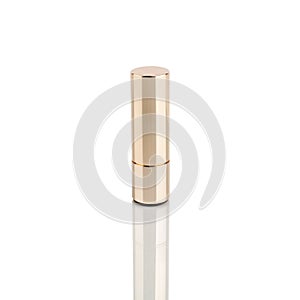 Lipstick in golden tube on white background with mirror reflection on glass surface isolated closeup, shiny gold lipstick package