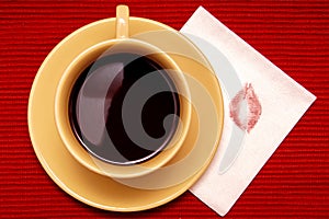 Lipstick kiss with cup of coffee