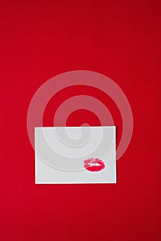 Lipstick marks kisses on white paper on red background