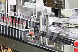 A lipstick packaging machine in a cosmetics factory