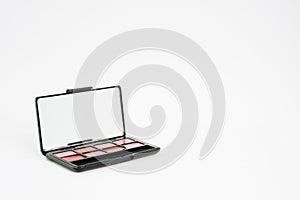 Lipstick palette box with mirror on isolated white background with copy space