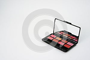 Lipstick palette box with mirror on isolated white background with copy space