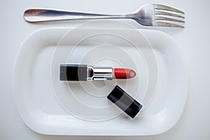 Lipstick on a plate with a fork