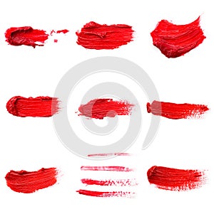 Lipstick smear smudge swatch isolated on white background. Cream makeup texture. Bright red color cosmetic product brush stroke