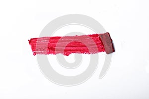 Lipstick smear smudge swatch isolated on white background. Cream makeup texture. Bright red color cosmetic product brush stroke