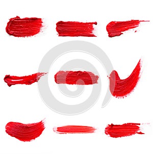 Lipstick smear smudge swatch isolated on white background. Cream makeup texture. Bright red color cosmetic product brush stroke sw