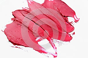Lipstick smear smudge swatch  on white background. Cream makeup texture. Bright red color cosmetic product brush stroke sw