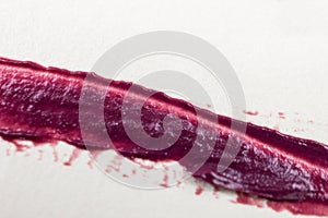 Lipstick smeared on a white background. Close-up