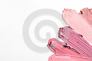 Lipstick smears isolated on white, top view.