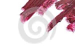 Lipstick smears on white background, top view.