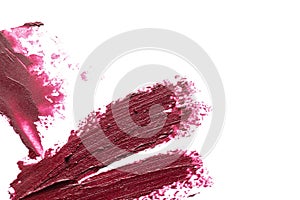 Lipstick smears on white background, top view.