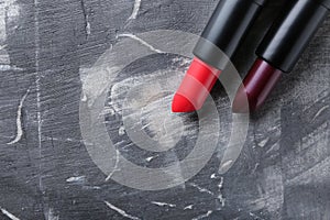 Lipsticks of different shades on grey background