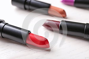 Lipsticks of different shades on light table