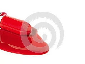 Lipsticks on red liquid .