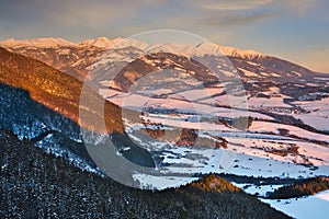 Liptov countryside and West Tatras from Janosikov stol rock during winter sunset