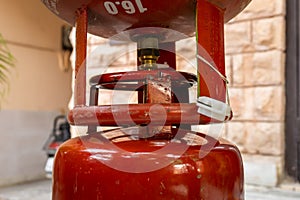 Liquefied Petroleum Gas cylinder refilling through valve close up at day