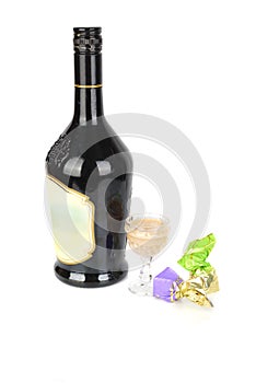 Liqueur black bottle with two sweets.