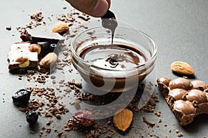 Liquid chocolate on a background of crumbs and dried berries and sweets