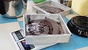 Liquid chocolate in tray on the scales to prepare baking ingredients