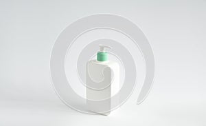 Liquid container for gel, lotion, cream, shampoo, bath foam. Cosmetic plastic bottle with green dispenser pump on white