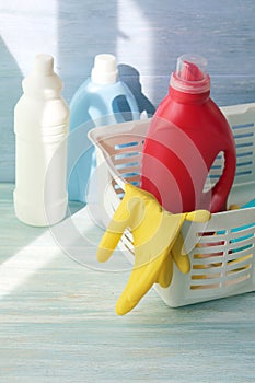 Liquid detergents in plastic bottles, rubber gloves for cleaning the house