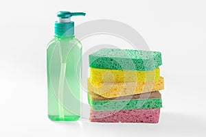 Liquid dish washing detergent with stack of sponges on white background