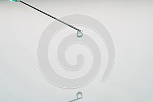 Liquid drop on the tip of syringe