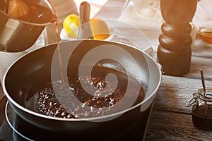 Liquid flowing onto frying pan.