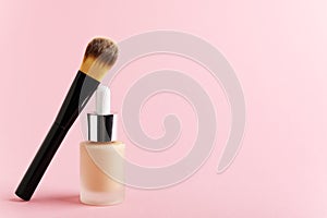 Liquid foundation cream unbranded bottle with makeup brush. Facial correction, liquid concealer, tone, bb, cc cream skincare