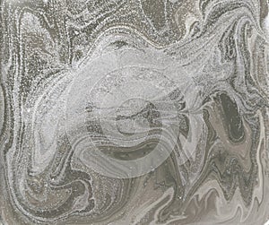 Liquid gold marbled pattern. Pale beige background