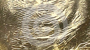 Liquid gold motion creates ripples and waves. Super shiny metallic gold surface hypnotic effect.