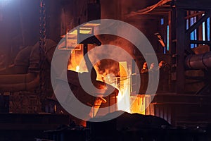 Liquid iron, molten metal pouring from ladle, metallurgical factory, foundry cast