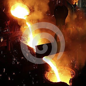 Liquid metal in the foundry, melting iron in furnace, steel mill photo