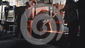 Liquid metal production. Steelmakers works in a foundry. Liquid metal in furnace