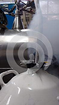 Liquid nitrogen tank being filled up at the cryogenics room photo