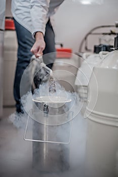 Liquid nitrogen technician fills container