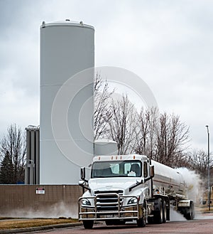 Liquid oxygen being unloaded from a semi truck into storage tanks at a medical facility in a residential district