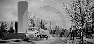 Liquid oxygen being unloaded from a semi truck into storage tanks at a medical facility in a residential district
