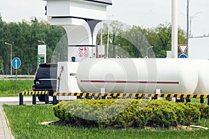 Liquid propane gas station. Black modern SUV car refueling tank with alternative power natural liquefied fuel