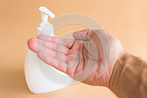 Liquid soap bottle and hand washing hands.