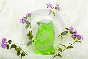 Liquid Soap and Flowers on White Lace