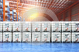 Liquid storage tank stack inside distribution warehouse. Industrial warehousing and logistics.