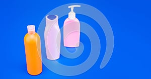 For liquid storing. Bottles with flip cap and pump dispenser. Cosmetic bottles blue background