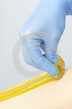 Liquid sugar for skin epilation. Close up shot. depilation and beauty concept - sugar paste/ vertical photo