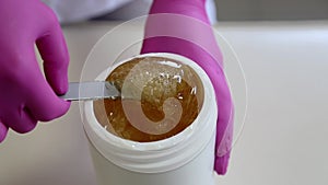 Liquid sugar for skin epilation. Close up shot. depilation and beauty concept - sugar paste or wax honey for hair