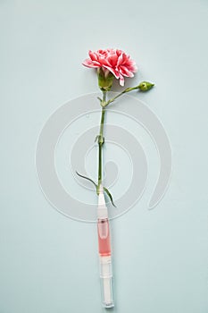 Liquid sustainable essence, cosmetic fluid with pink flower based on blooming. Multiuse. Skin care beauty products on photo