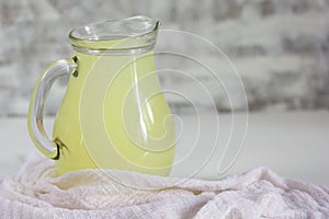Liquid whey that remains after formation of curds in jar on white background